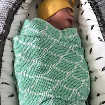 Newborn baby wrapped in a mint green and white organic cotton baby blanket. Passionfruit and Lemonade